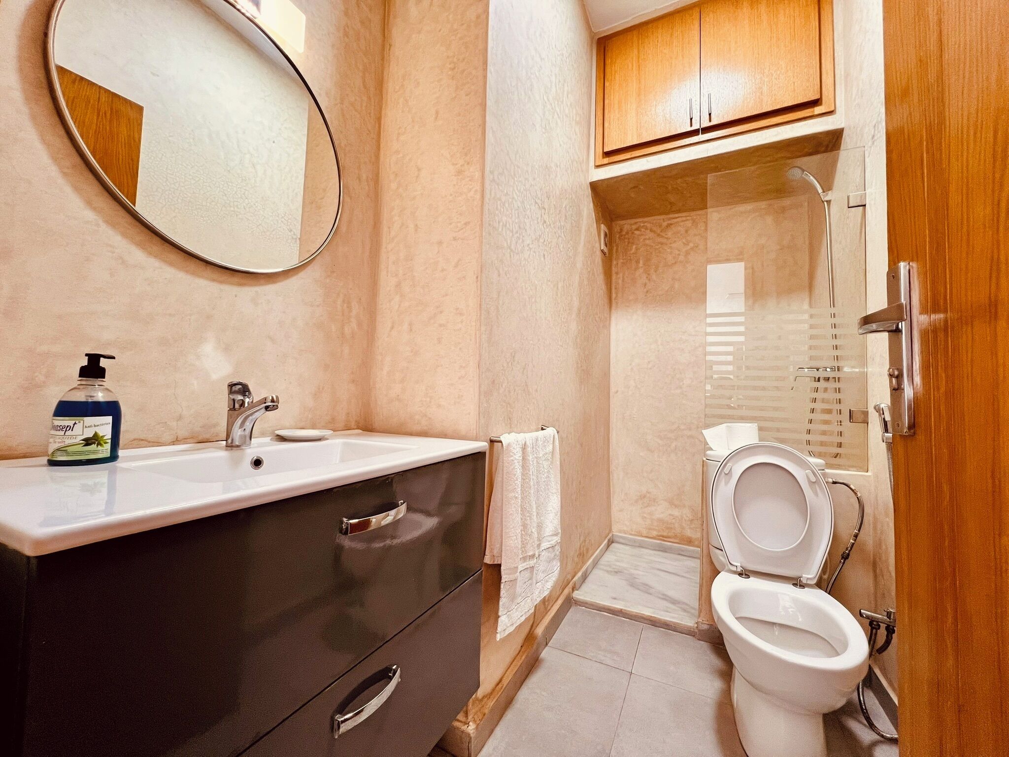 A bathroom with a sink, mirror, and toilet.