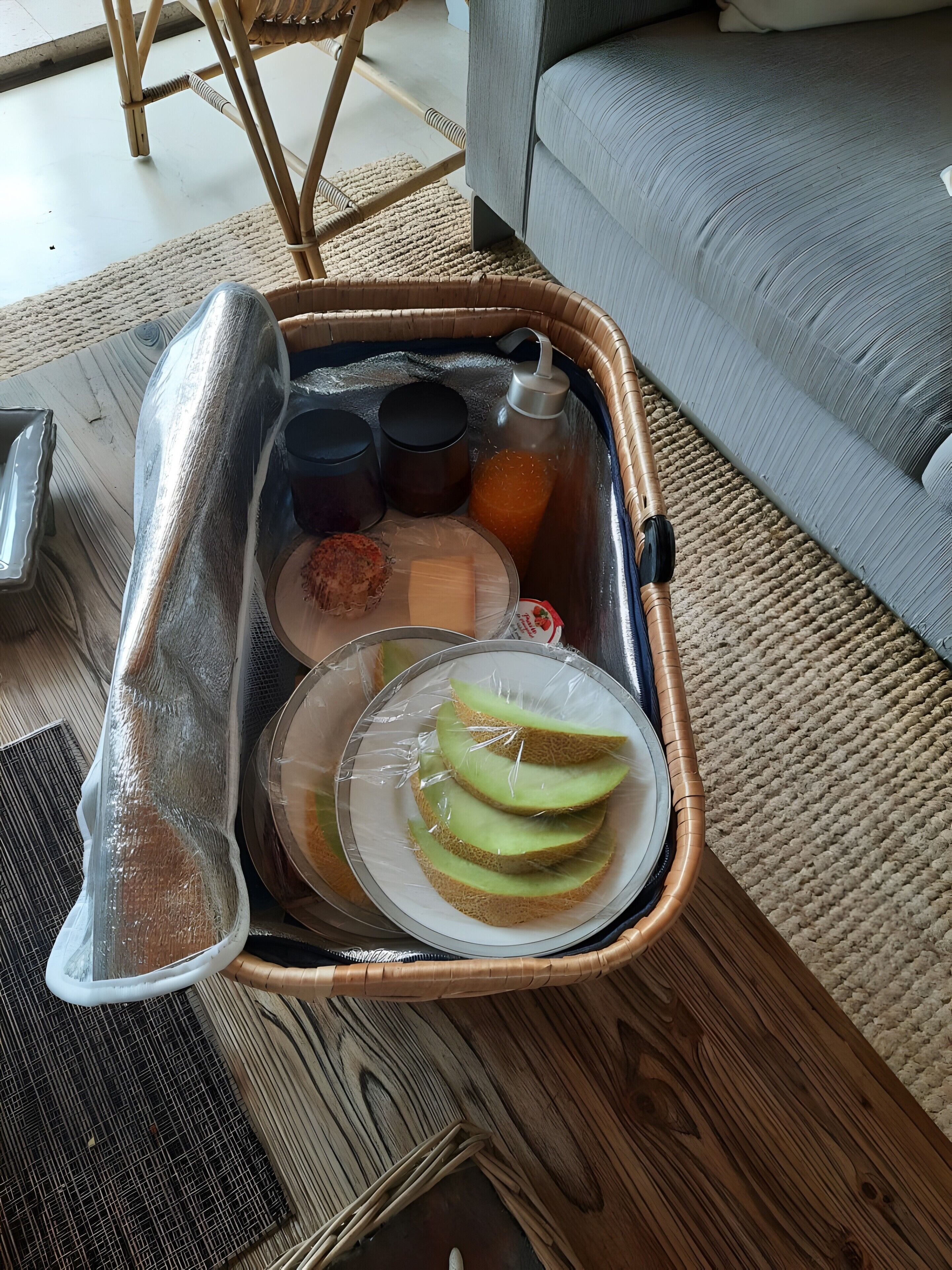 A tray with food items and drinks on a wooden table.