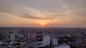 A cityscape at sunset with high-rise buildings and a clear sky.