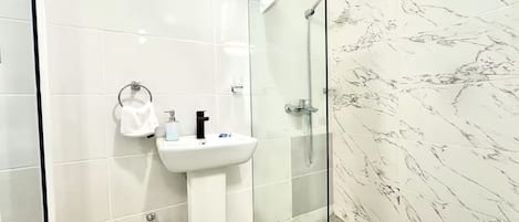 Shower, towels, soap, toilet paper