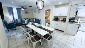 A modern apartment with a dining area, kitchen, and living room. - NEW! Direct Bayfront Sunsets - Boat Docks - Pool - Fish (South Padre Island)