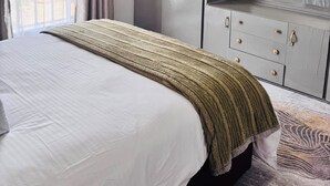 A bedroom with a large bed, a wardrobe, and a mirror. - A Calm, Elegant 3BR retreat in Milimani, Kitale (Kitale)
