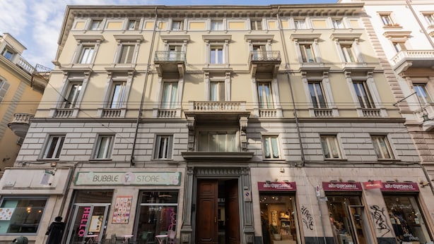 A multi-story building with a ground-floor shop named 'Bubble Store'. - Cheerful Apartment XX Settembre by Wonderful Italy (Turin)