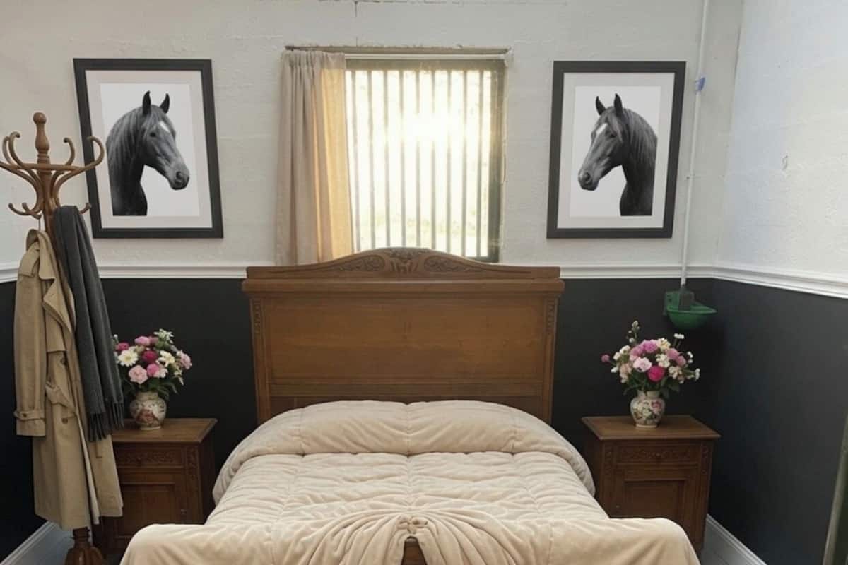 A bed with a wooden headboard, two nightstands with flower vases, and two framed horse portraits on the wall.