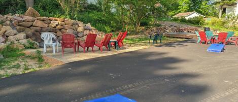 Outdoor seating with chairs and a blue board game.