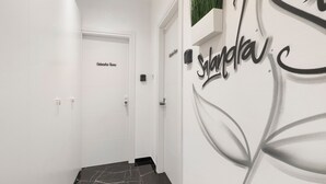 A hallway with a white door labeled 'Galanharra Home,' a wall-mounted sign with 'Syrindau,' and a black marble floor. - 'Salandra' Room with Wi-Fi and Air Conditioning (Bari)