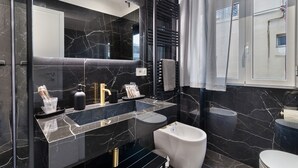 A modern bathroom with a black marble sink, a white toilet, and a bidet. - 'Salandra' Room with Wi-Fi and Air Conditioning (Bari)