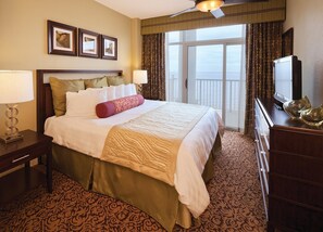 A hotel room with a large bed, a television, and a view of the ocean. - Ocean Front Condo in North Myrtle Beach. 
2 bedroom 2 bath w/direct beach access (Myrtle Beach)