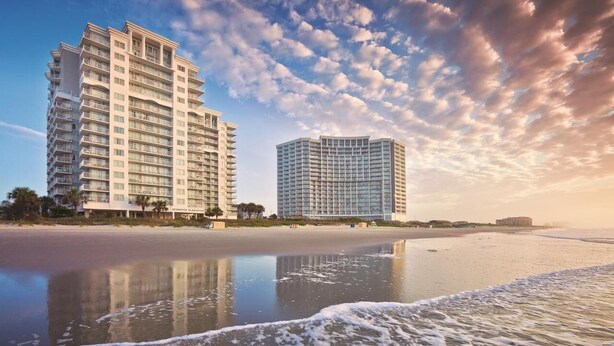 A beachfront hotel with multiple floors, a pool, and a view of the ocean. - Ocean Front Condo in North Myrtle Beach. 
2 bedroom 2 bath w/direct beach access (Myrtle Beach)