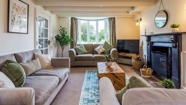 Un salon confortable avec un canapé, une table basse et une cheminée.