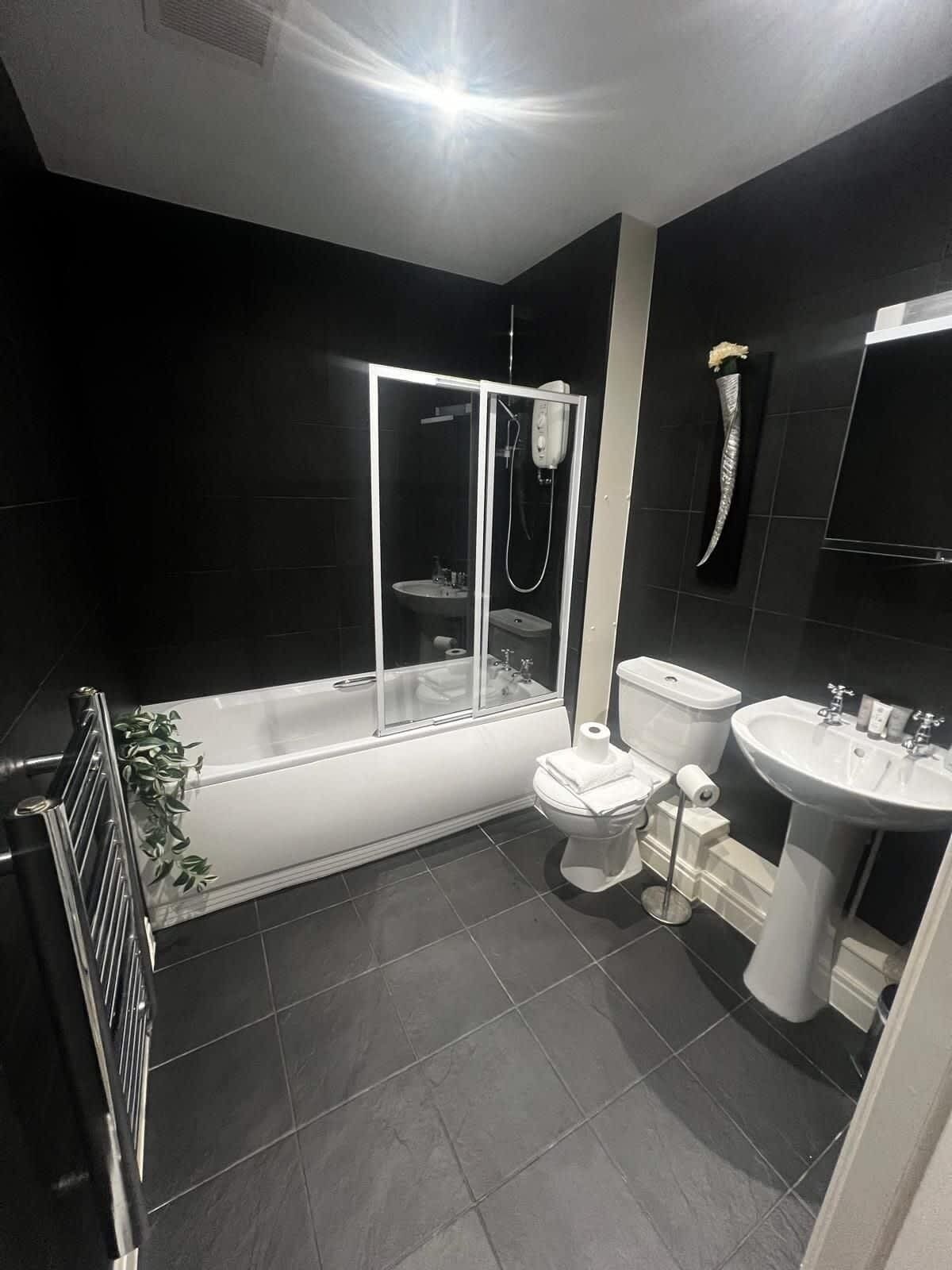 Shower, hair dryer, towels, shampoo