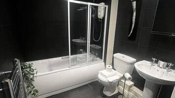 Shower, hair dryer, towels, shampoo
