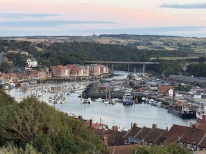 A harbor with boats, a bridge, and buildings in the background. - Modern & spacious harbour-view apartment & parking (North Yorkshire)
