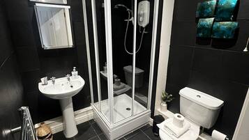 Shower, hair dryer, towels, shampoo