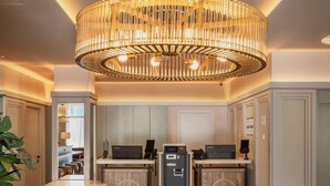 A modern kitchen with a central chandelier, wooden cabinets, and a built-in coffee machine. - B&B HOTEL Madrid Vallecas Ensanche (Madrid)