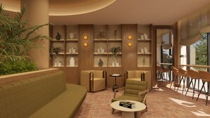 Ein modernes Wohnzimmer mit einer Couch, Sesseln, einem Couchtisch und einem Bücherregal mit Dekoration.
