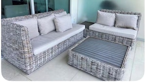 A wicker sofa set with cushions and a matching ottoman on a tiled patio. - PENINSULA NUEVO VALLARTA BEAUTIFUL CONDOMINIUM (Las Jarretaderas)