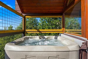 A hot tub with a wooden deck and a view of trees and sky. - Mountain Top Cabin With Views Hot Tub and Arcade (Sevierville)