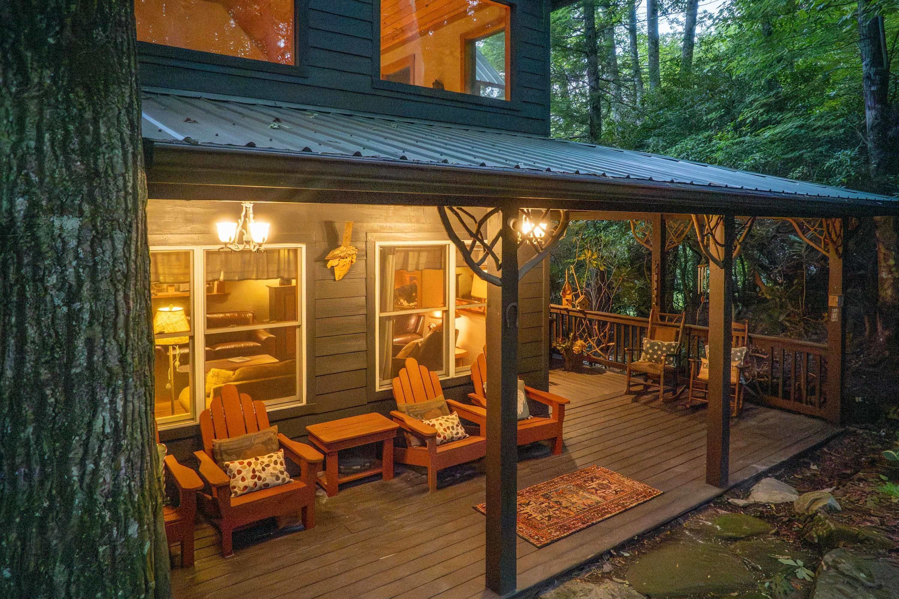 A wooden deck with outdoor seating and a covered area.