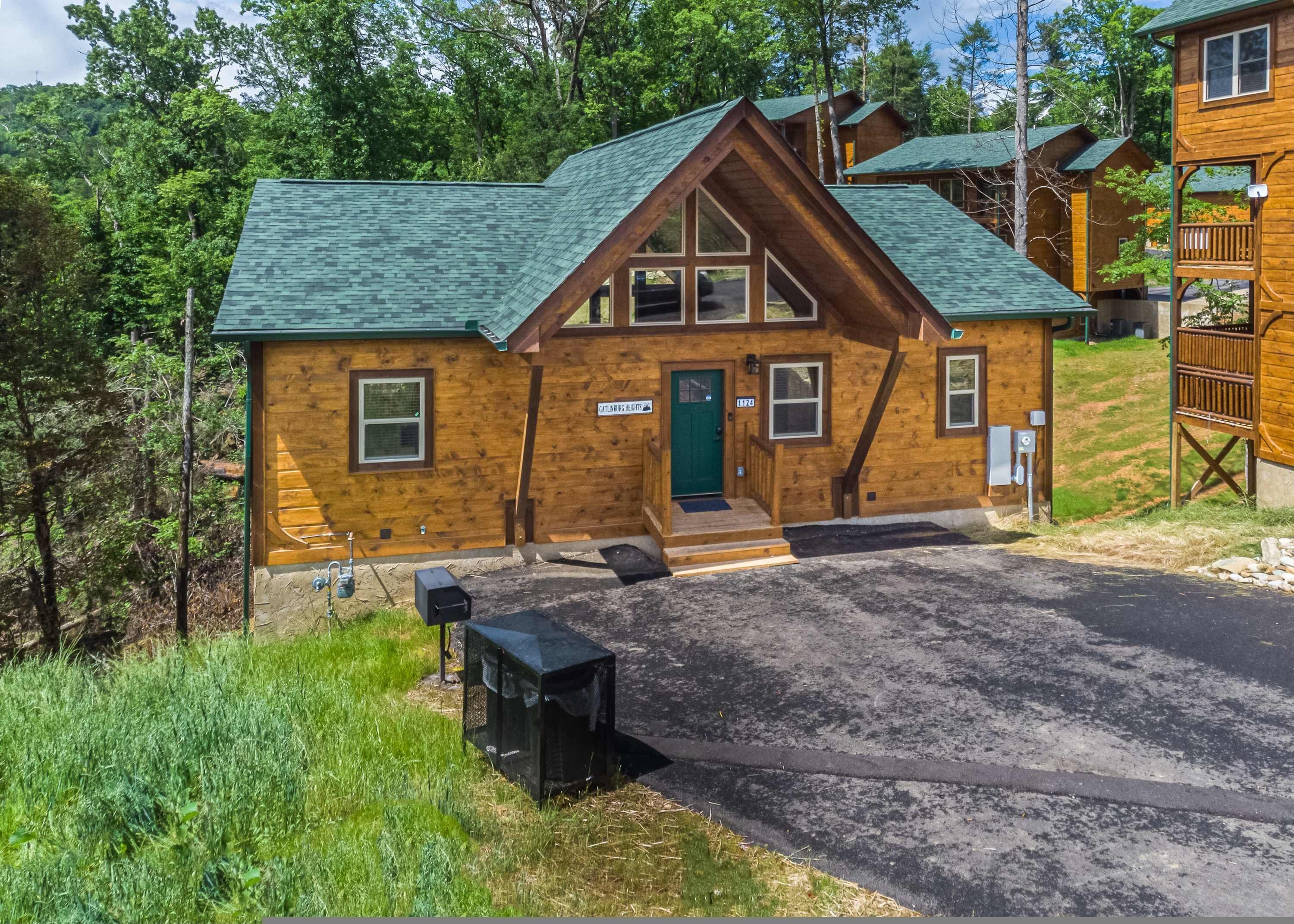A lodge with a green roof, wooden exterior, and a front porch.
