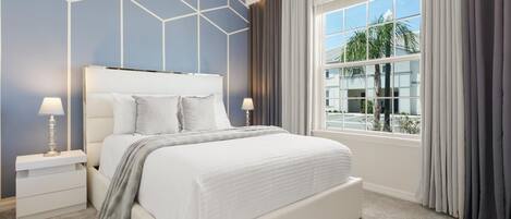 A modern bedroom with a large bed, two bedside tables, and a window with curtains.