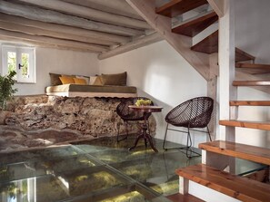 A rustic room with a stone wall, a glass table, and a wooden bench. - Villa Rheline, Divine Sea Views, Private Pool, Spacious Furnished Terrace,. (Zakynthos)