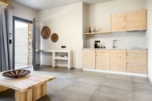 A modern kitchen with wooden cabinets, a built-in sink, and a dining area with a bench. - Villa Lysmere, Private Pool, Spacious Furnished Terrace, Thassos (Thasos)