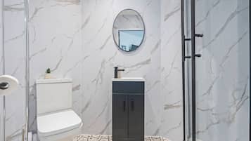 Shower, hair dryer, towels, toilet paper