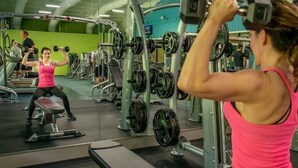 A gym with various exercise equipment and a person lifting weights. - Cozy 1-bedroom resort with AC in welcoming Massanutten with waterPark access (Massanutten)