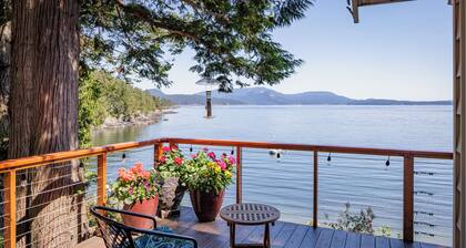 Watch ferries come and go from this cozy waterfront home on Shoal Bay.