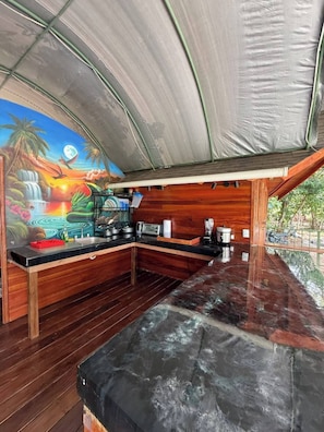 A kitchen with a wooden countertop, a sink, and a stove. - Dragon Majick (Pavones)