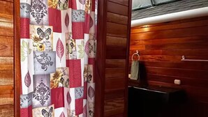 A room with a wooden wall and a patterned curtain. - Dragon Majick (Pavones)