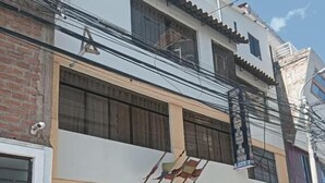 A two-story building with a ground-floor shop and upper residential units. - HOTEL SAN ANTONIO  (Puno)