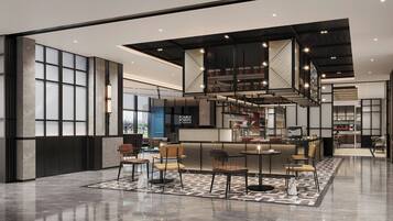 A spacious lobby with a central seating area, a staircase, and a bar.