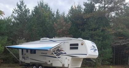 27 foot fifth wheel on a small private campground. Pets allowed.