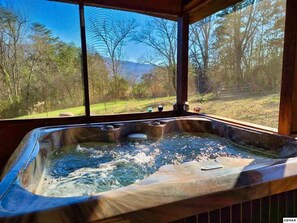 A hot tub with a view of a forest and mountains. - Beautiful View Log Cabin Fireplace Hot Tub Arcade Pool Fishing (Sevierville)