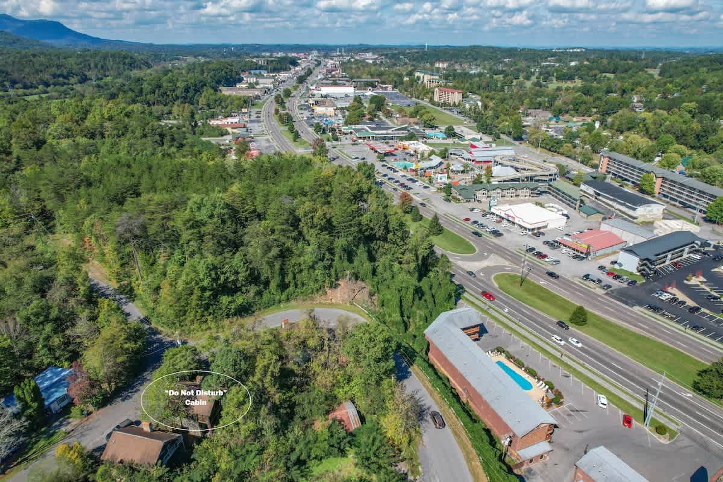 An aerial view of a commercial area with a prominent building labeled "Do Not Disturb Cabin."