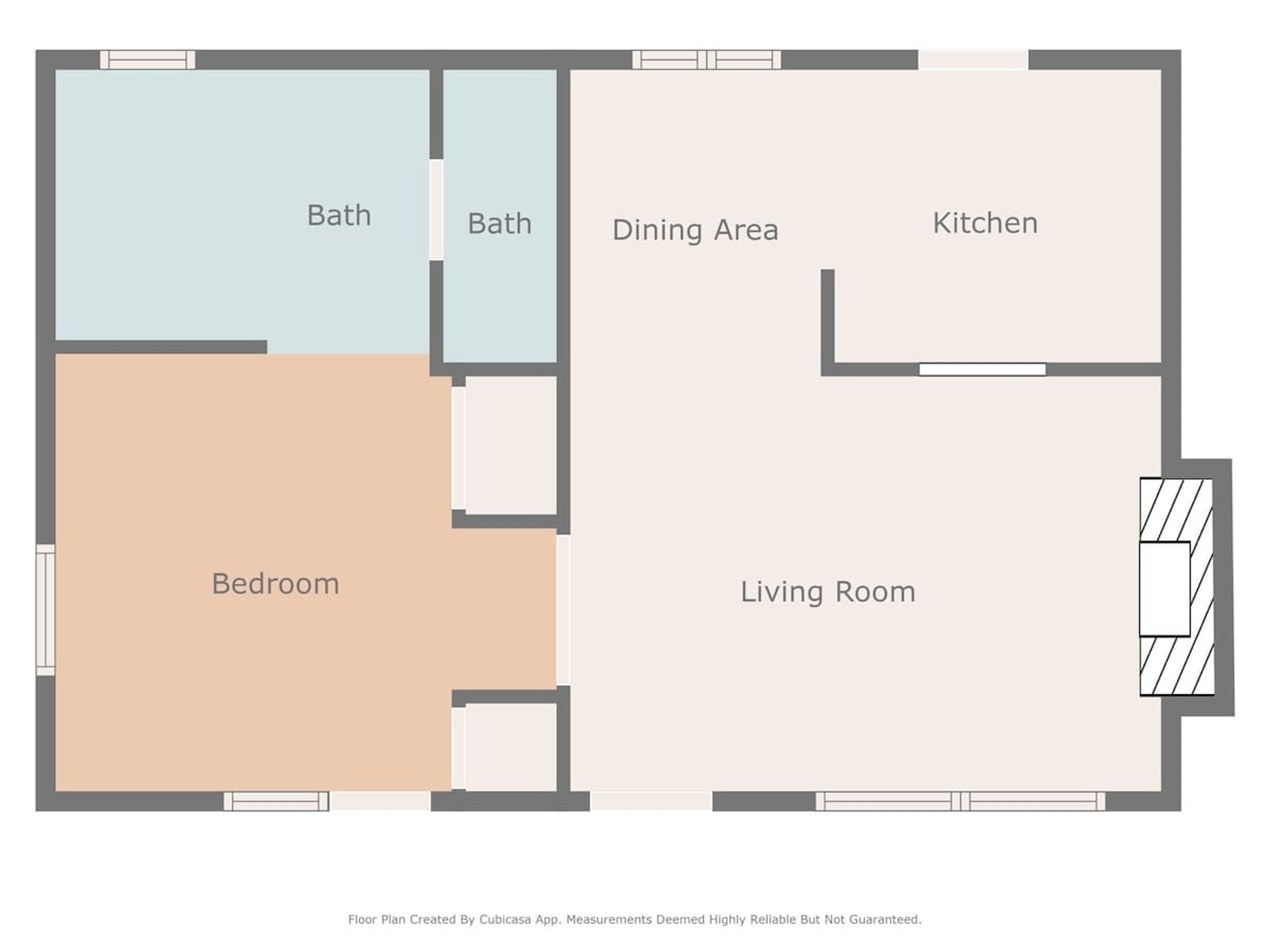 Un plan d’étage comprenant une chambre, deux salles de bain, un coin repas, une cuisine et un salon.