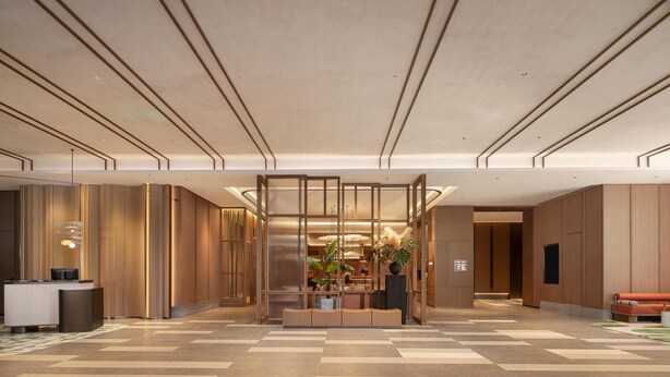 En modern hotellobby med en receptionsdisk, en sittgrupp och en stor växt.