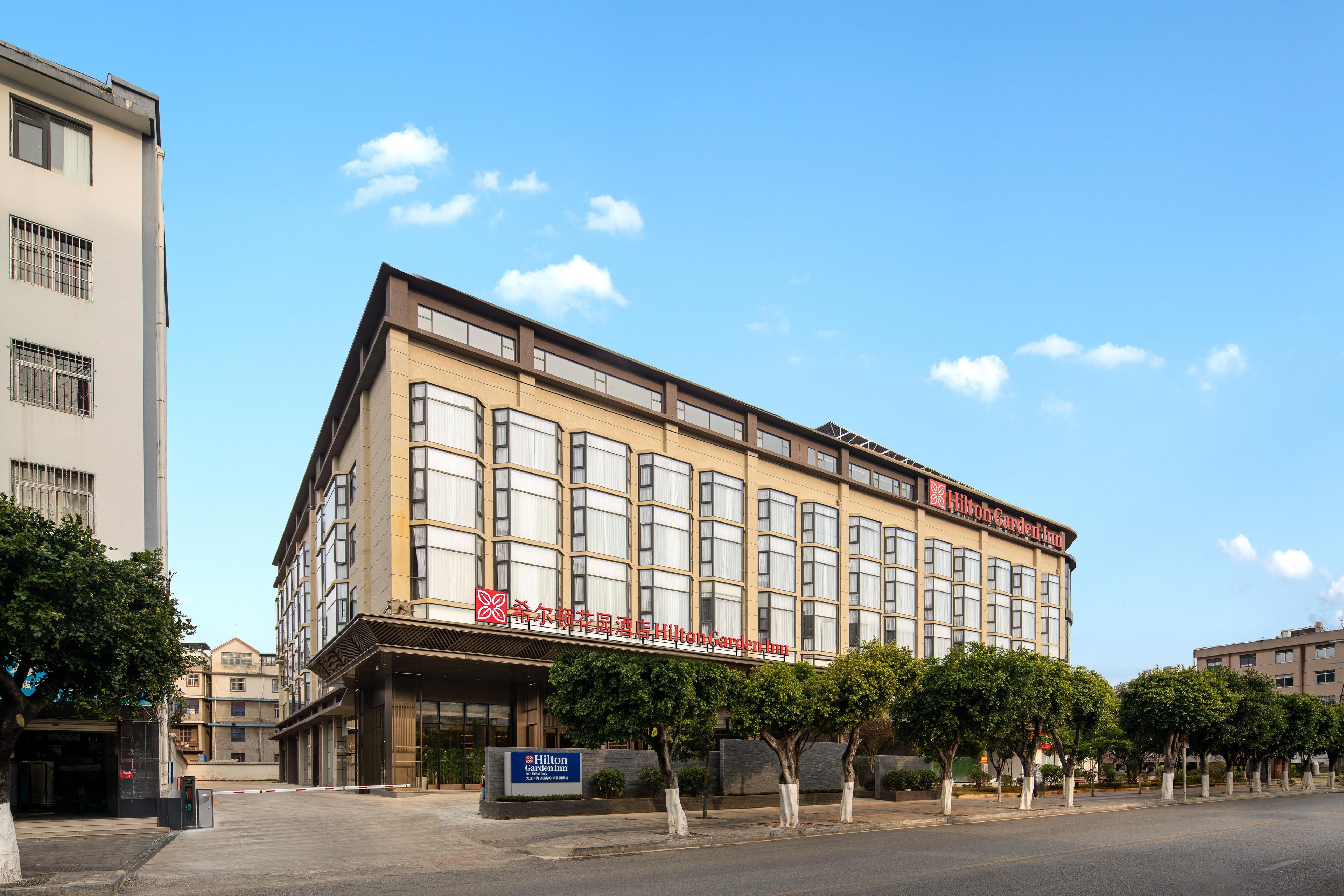 Ein mehrstöckiges Gebäude mit einer auffälligen Schilderung für Hilton Garden Inn.