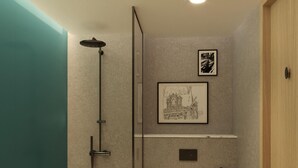 A modern bathroom with a glass shower enclosure, a toilet, a trash bin, and a framed picture on the wall. - The 6th Bridge Suites Porto, Tapestry Collection by Hilton (Porto)
