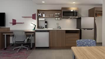 A compact kitchen with a microwave, refrigerator, and built-in dishwasher.