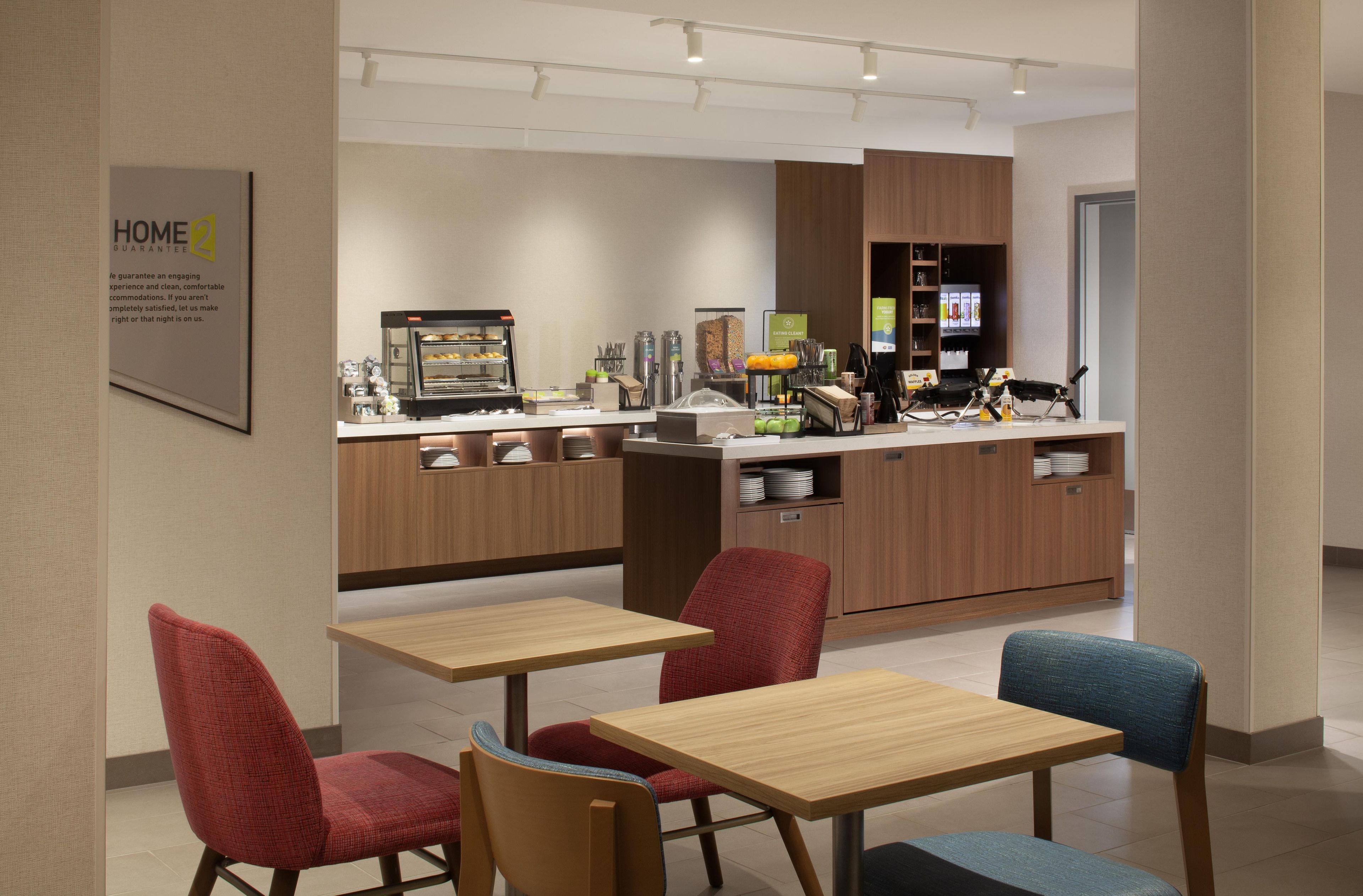 A modern cafe with wooden furniture, a coffee machine, and a menu board.