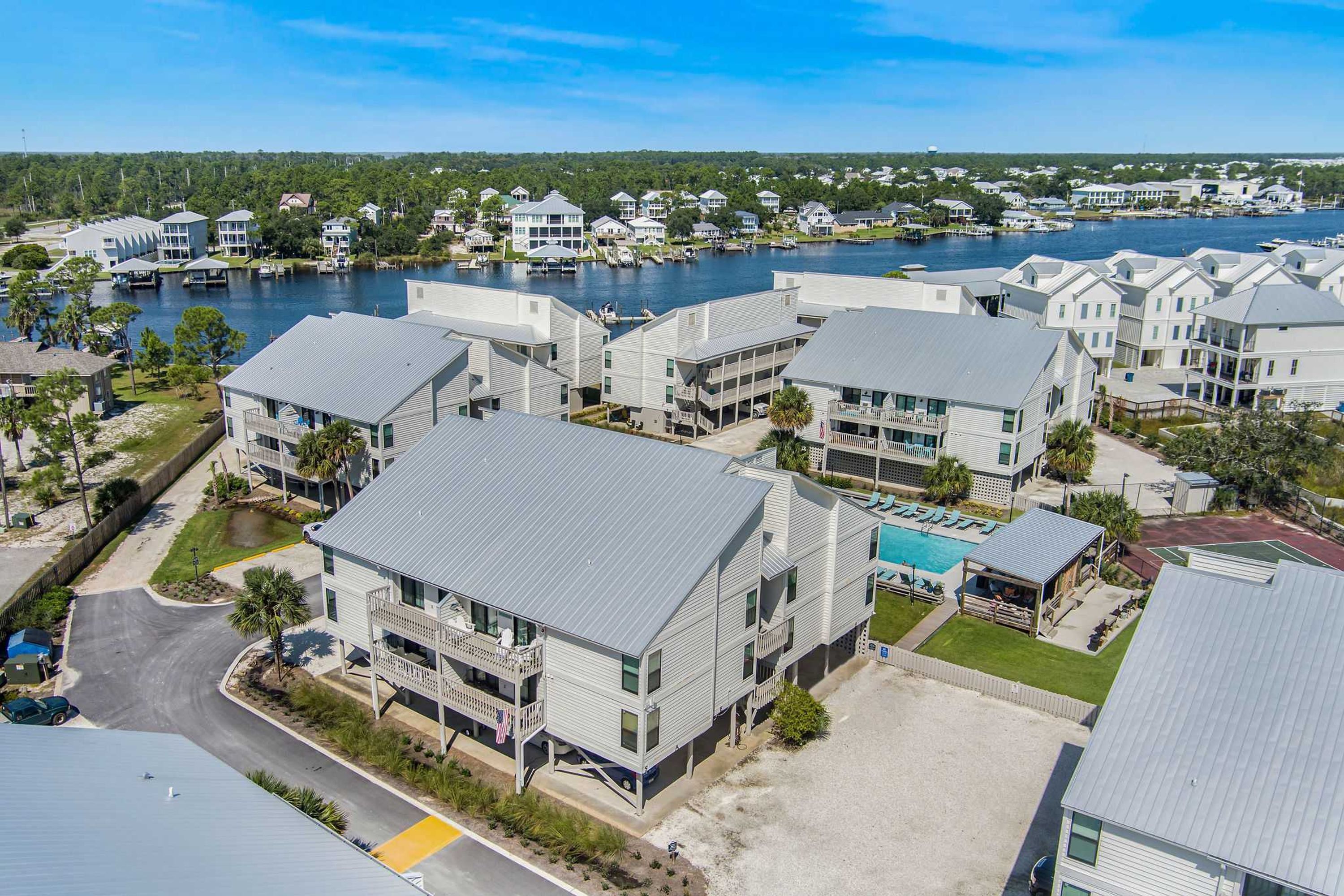 A coastal residential area with modern houses, a swimming pool, and a marina.