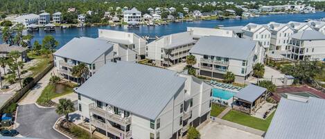 A coastal residential area with modern houses, a swimming pool, and a marina.