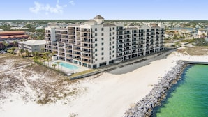 A multi-story hotel with balconies, a pool, and a beach view. - Grand Pointe 512 Gulf-front Stunning Views Top-notch Amenities 2 Bedrooms 5th Floor (Orange Beach)