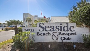 A sign for Seaside Beach & Racquet Club with the address 24522. - Seaside Beach 3902- 2 BR Direct Beachfront Condo With Pool Sauna Amazing Ocean View Balcony (Orange Beach)