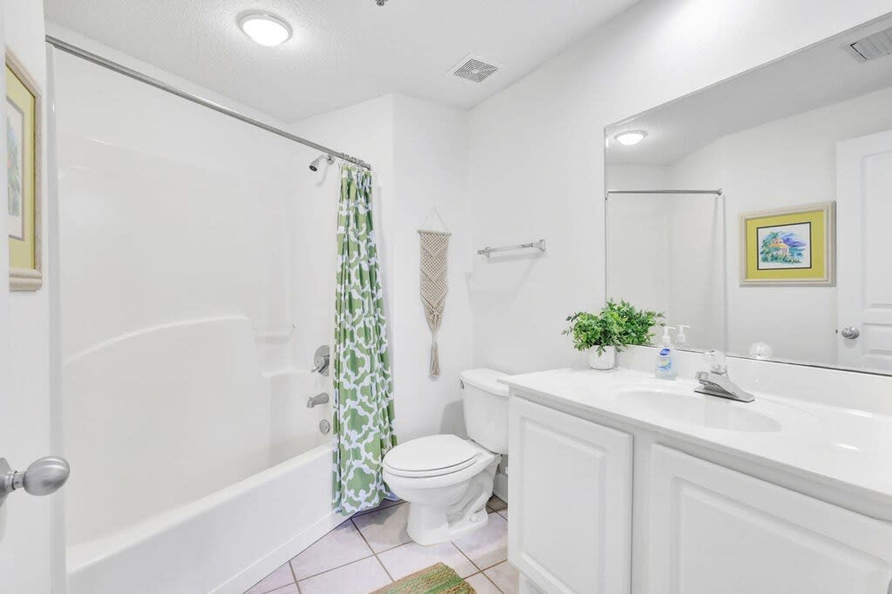 A modern bathroom with a bathtub, toilet, and sink.