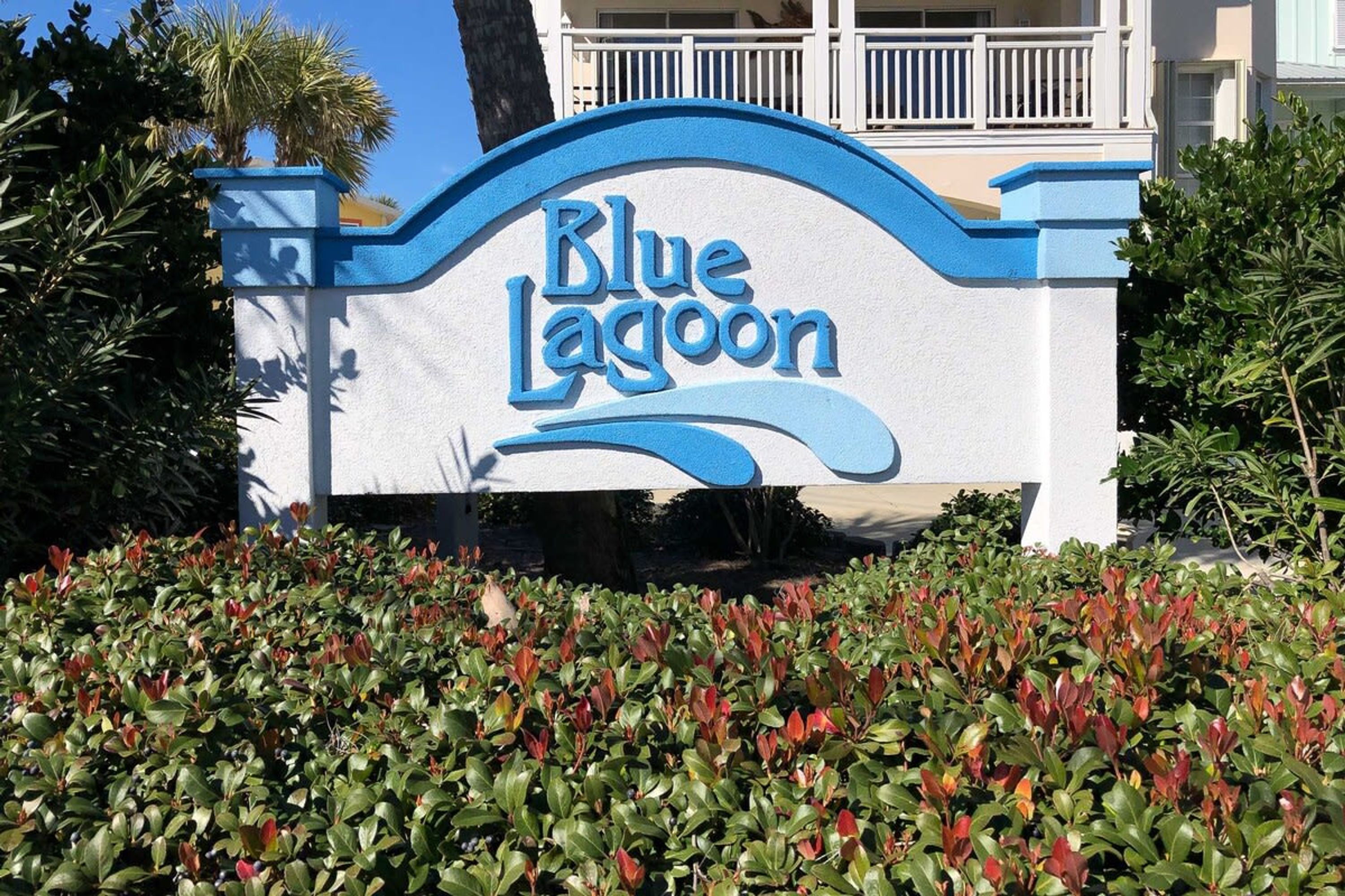 Een Blue Lagoon bord met een golvend ontwerp, omringd door keurig onderhouden hagen.