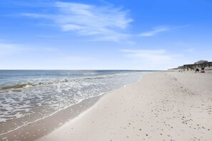 A beach with a wooden pier and a few people walking. - Don t Worry Beach House 3 2 2 Blocks to Beach (Gulf Shores)